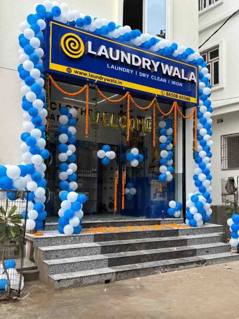 Laundrywala premium laundry and dry cleaning franchise storefront decorated with balloons, showing brand signage and glass entrance. A modern Laundrywala shop offering washing, dry-cleaning, ironing, and home pickup services in India. Perfect representation of Laundrywala franchise setup for entrepreneurs looking to start a profitable laundry business.